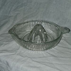Vintage orange lemon juicer.  This is glass with a pour spout and a thumb holder